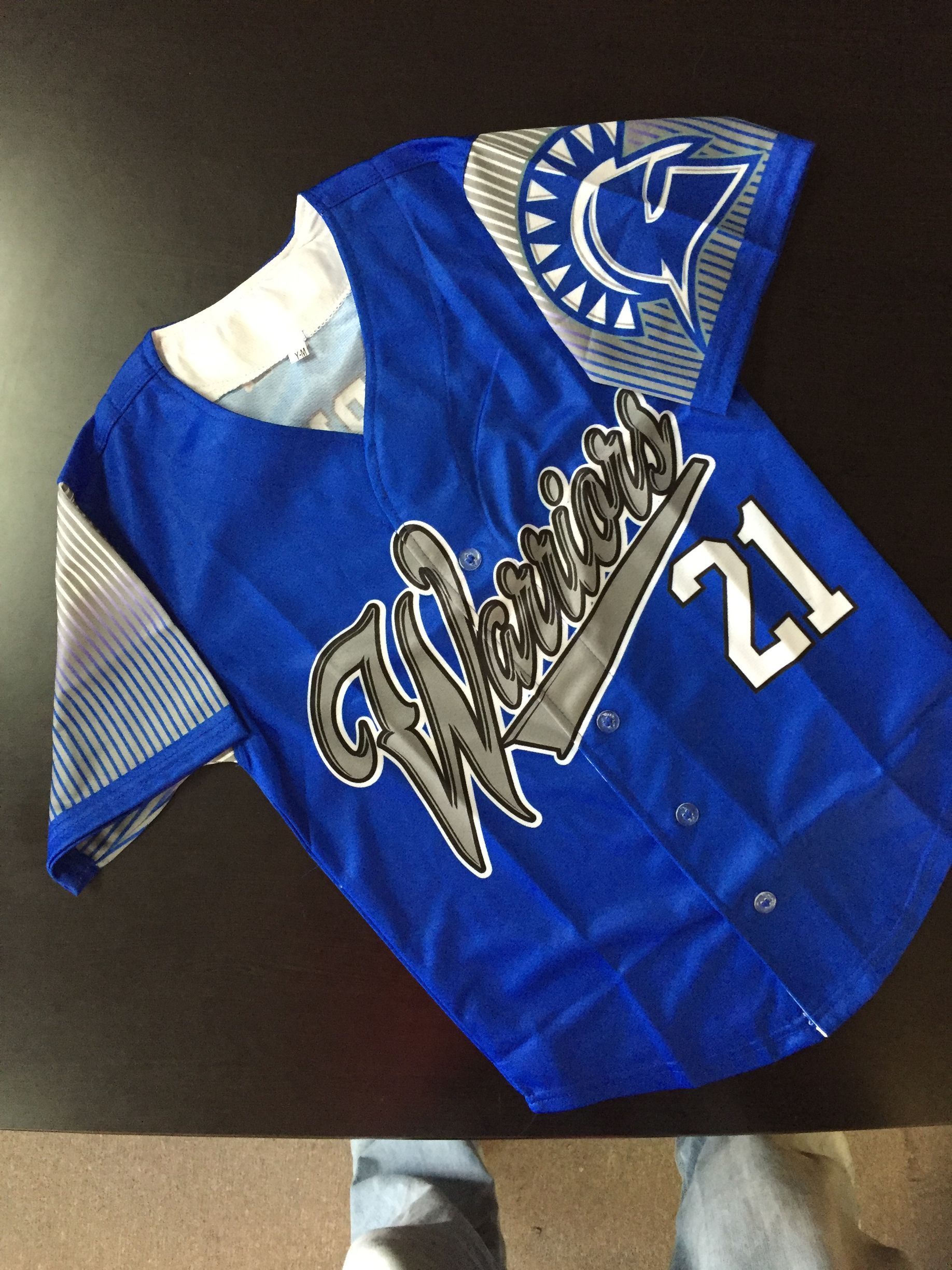 Blue baseball jersey with Warriors across the chest 