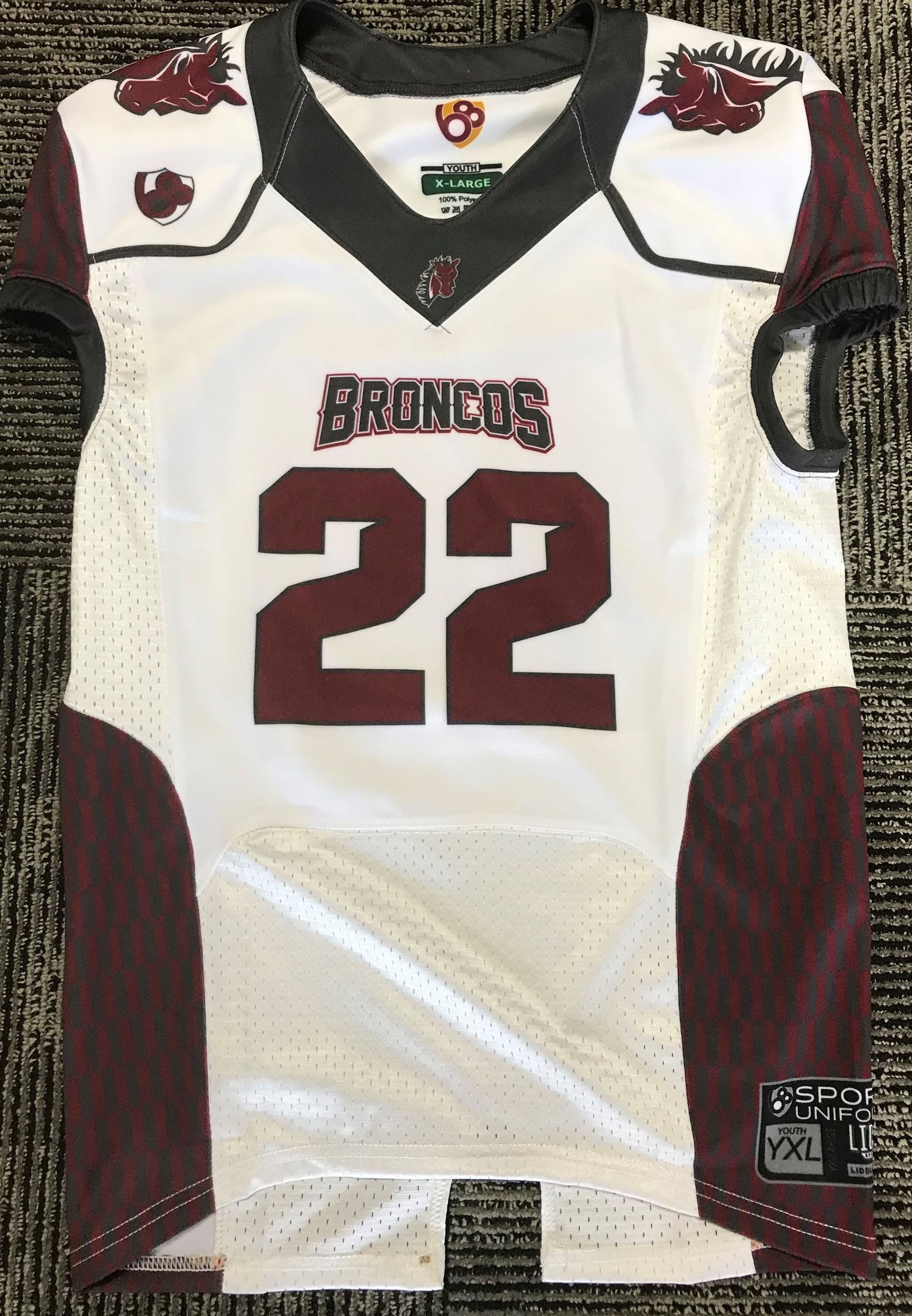 White Broncos jersey with maroon accents and the number 22.