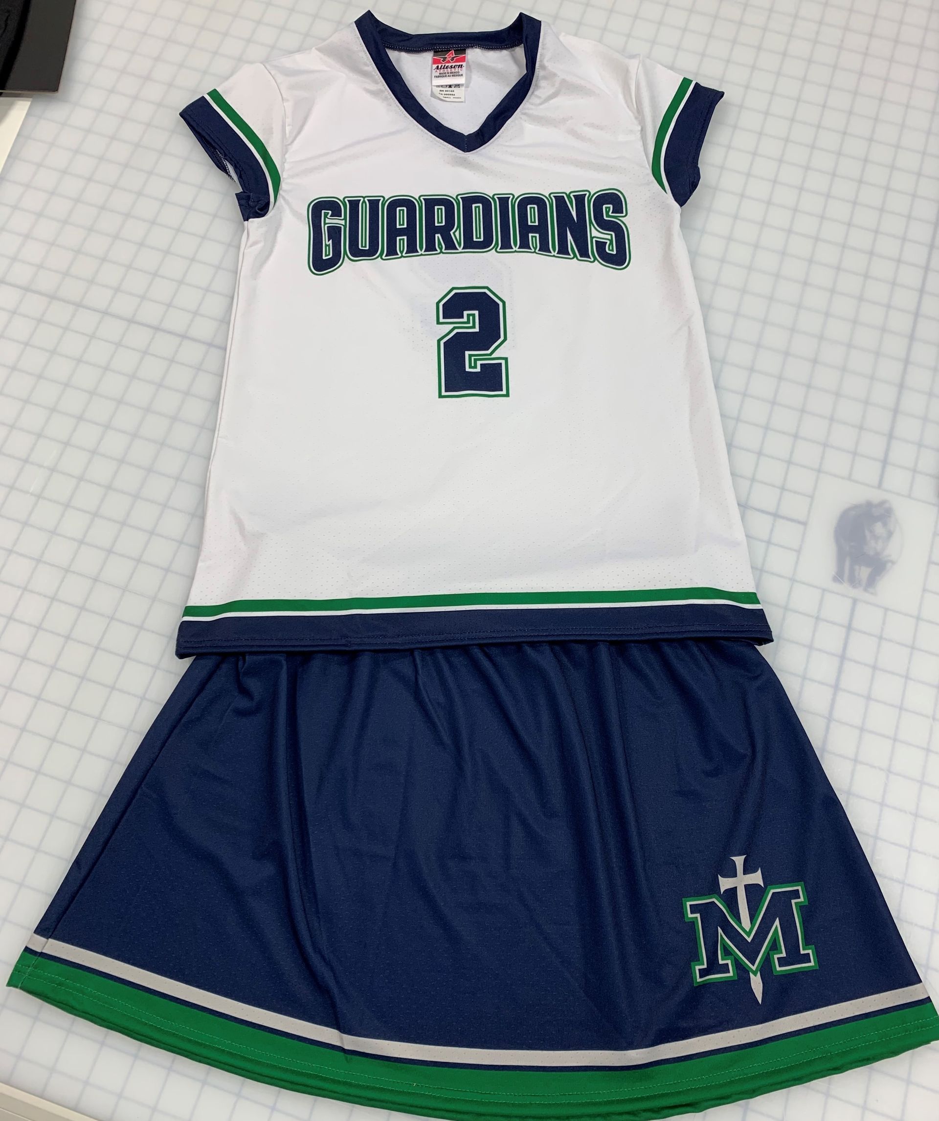 White and navy Guardians jersey with matching skirt, green trim, and number 2.