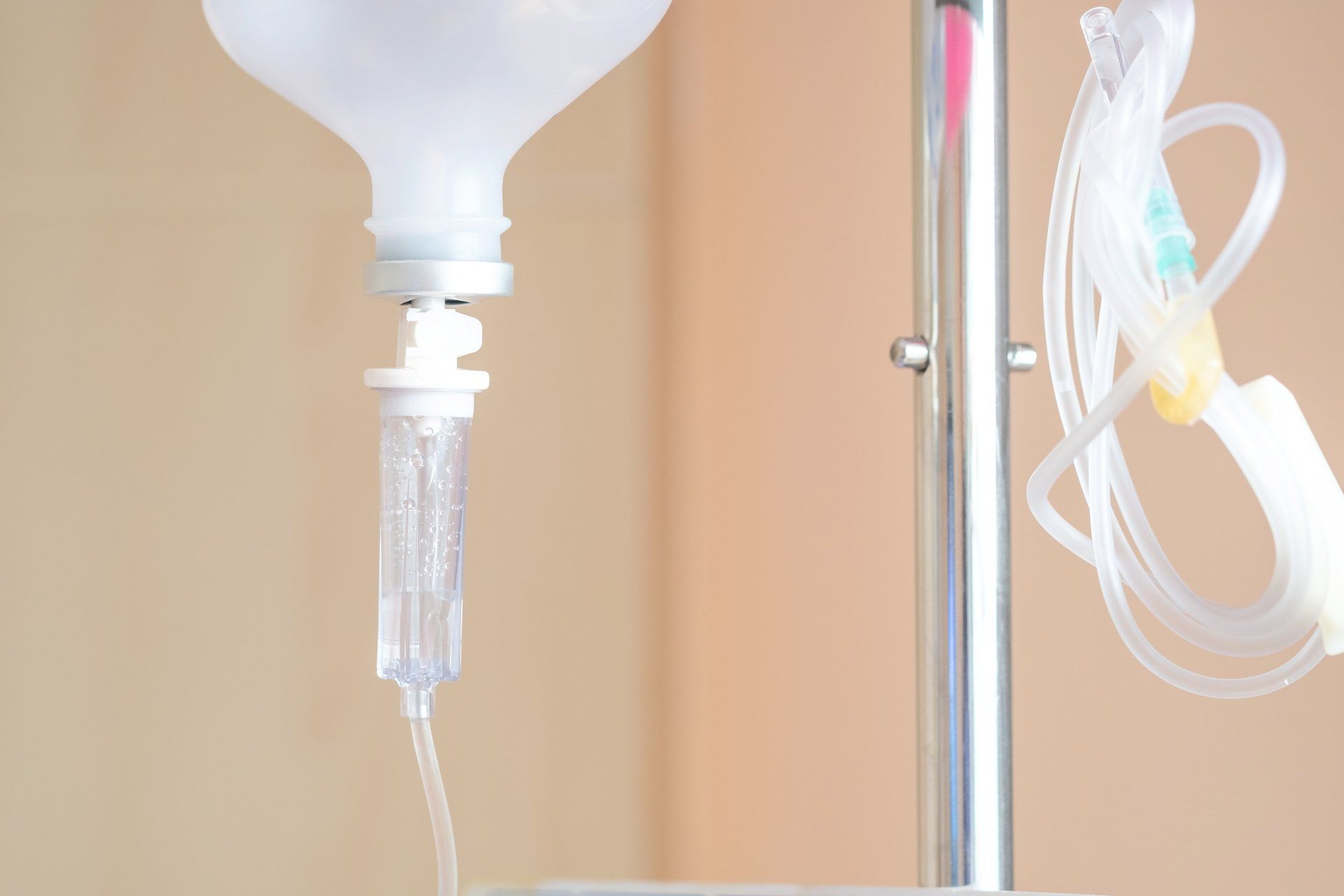 IV bottle with drip cartridge and tubing on a stand