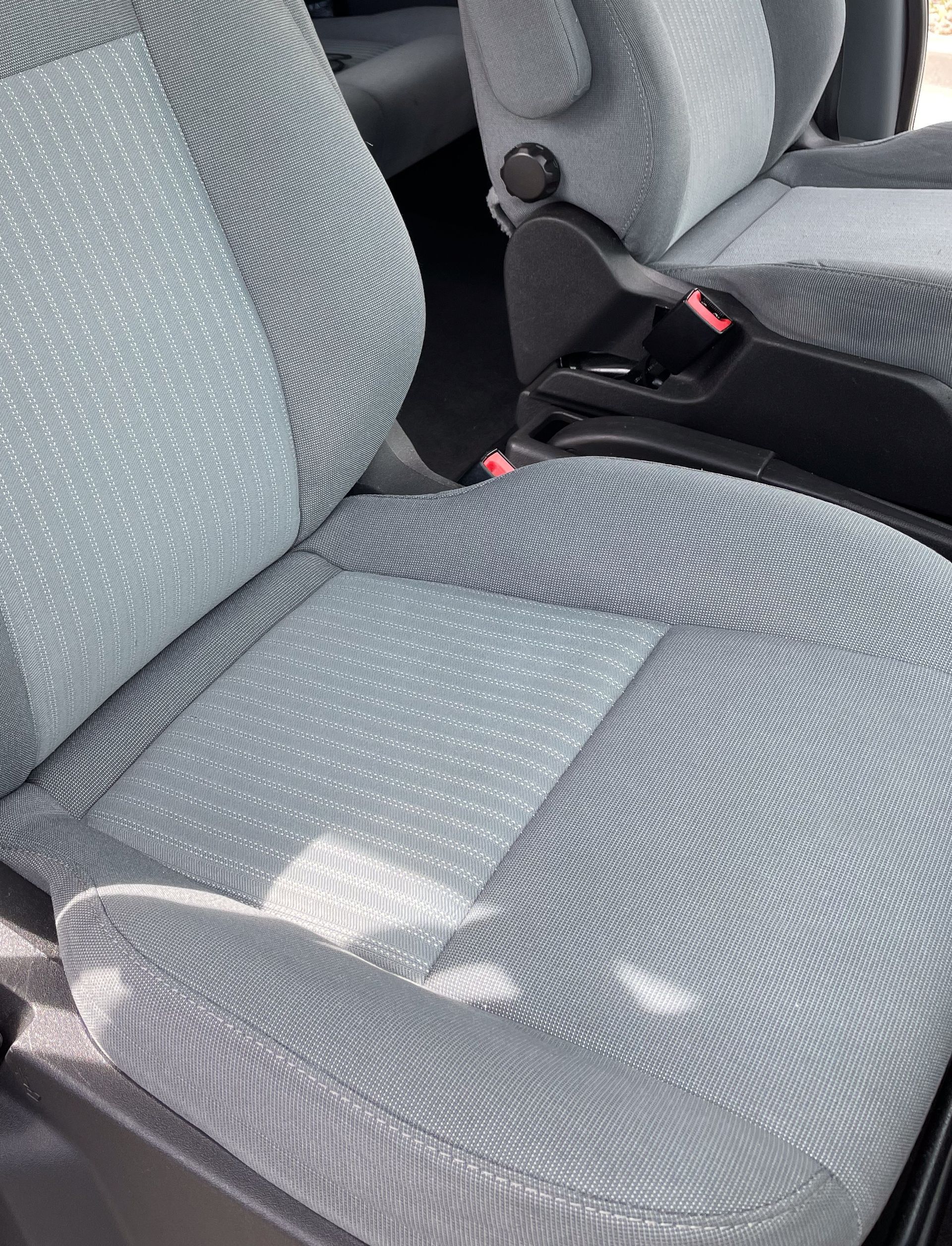 Gray fabric car seat with patterned texture; close-up view.