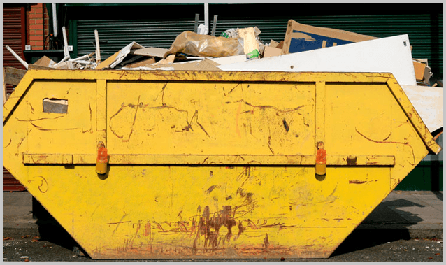 a large yellow skip with items inside