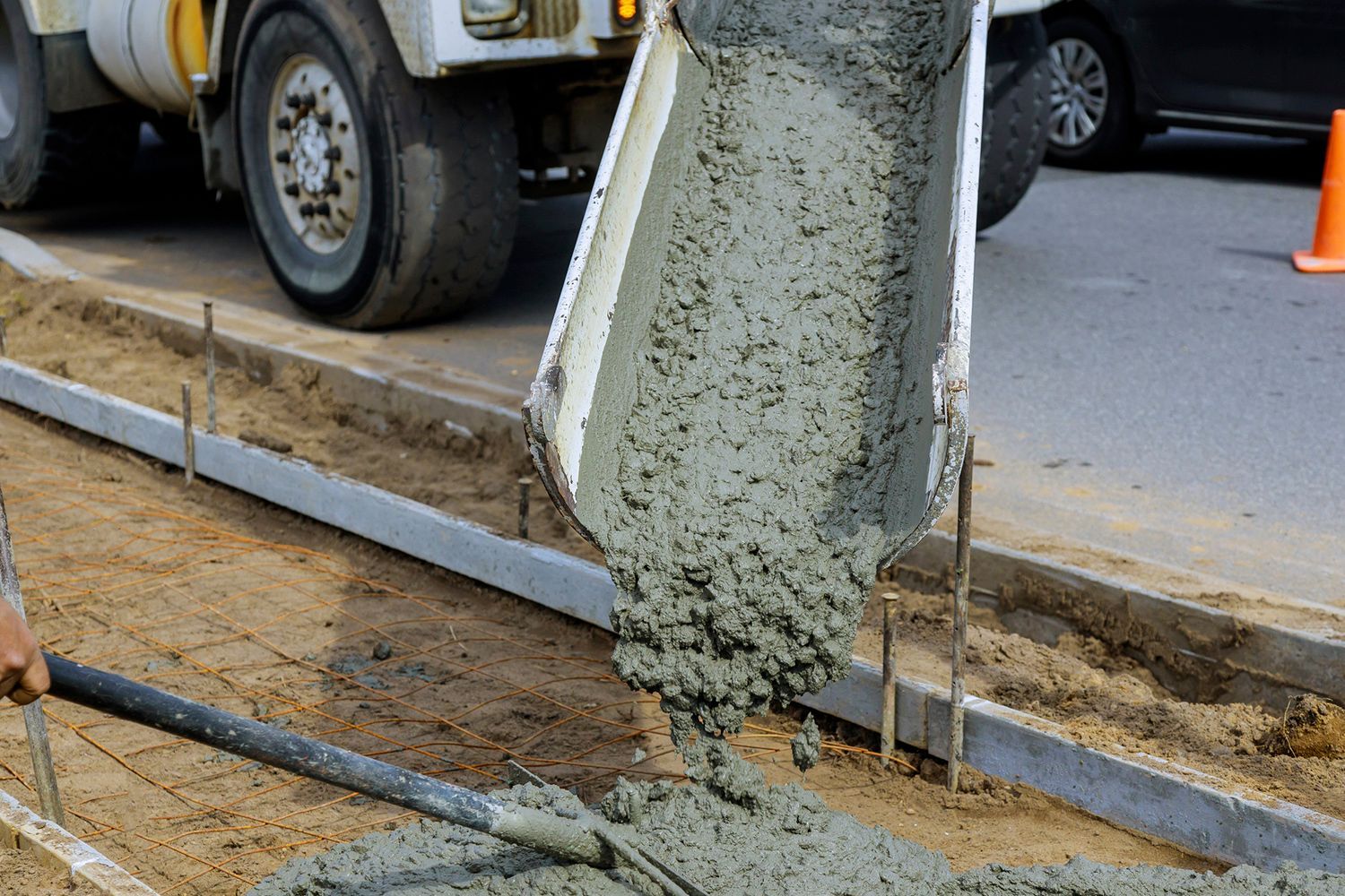 Concrete being poured from a truck into a form for a sidewalk. Concrete being poured from a truck into a form for a sidewalk.