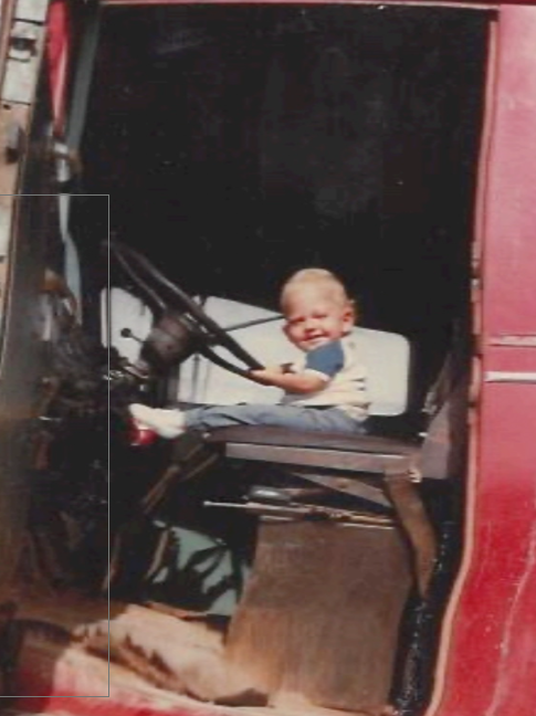 Exterior view of white building with black trim, accessible parking, and landscaping. White building with black trim, accessible parking, paved pathway, and landscaping.