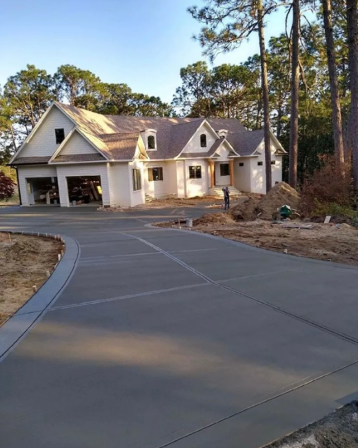 Brick house with concrete driveway bordered by red bricks and green grass. Brick house with concrete driveway bordered by red bricks and green grass.