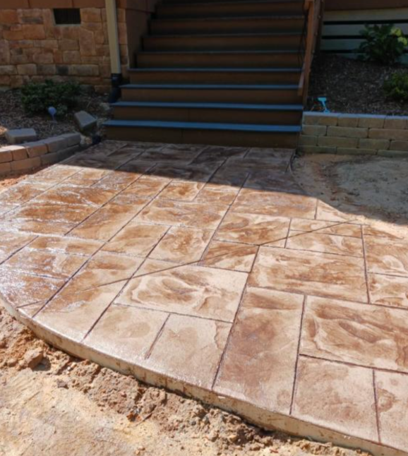 Textured dark concrete patio with a stone pattern. Textured dark concrete patio with a stone pattern.