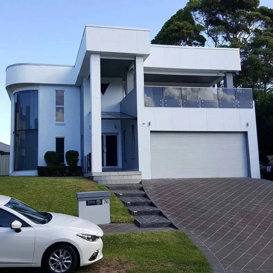 A White Car is Parked in Front of a White House — D & J Saverino Painting & Decorating Pty Ltd In Fairy Meadow, NSW
