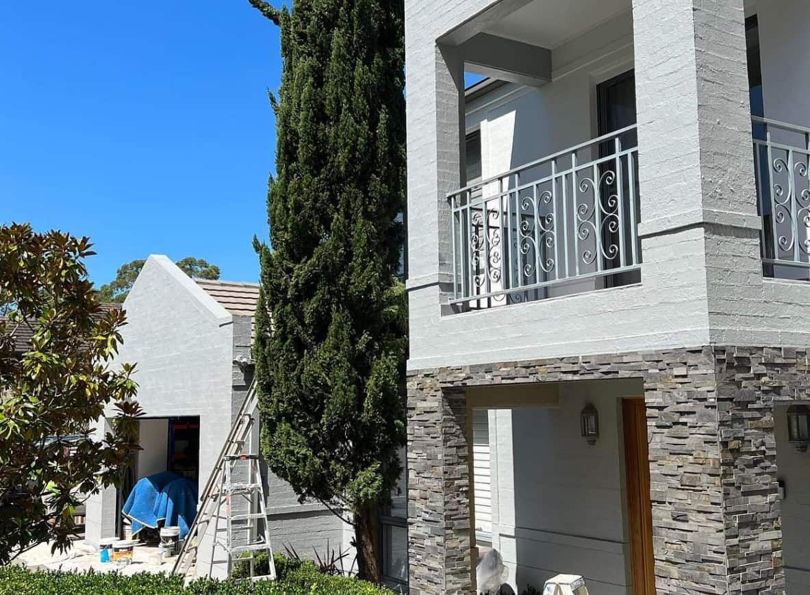 A Large White House With a Balcony is Being Painted — D & J Saverino Painting & Decorating Pty Ltd In Nowra, NSW