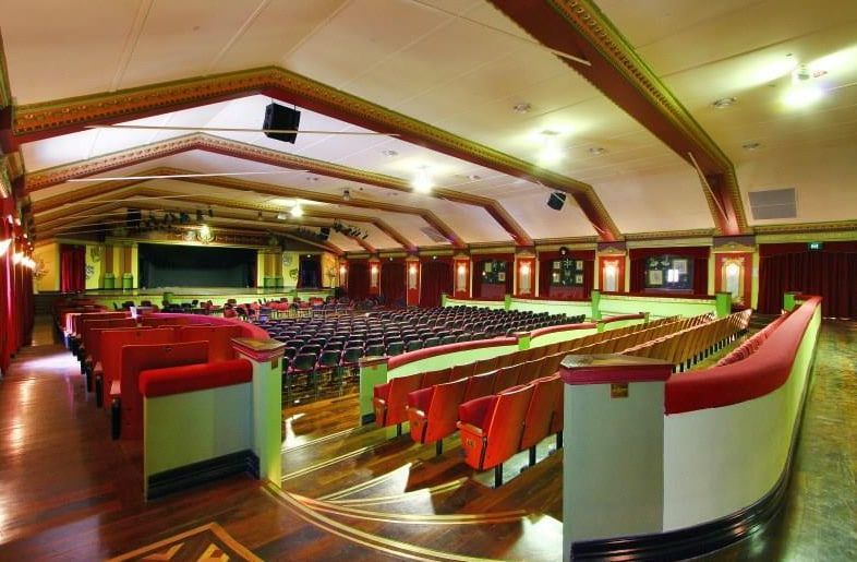 A Large Auditorium With Red Seats and a Stage — D & J Saverino Painting & Decorating Pty Ltd In Fairy Meadow, NSW
