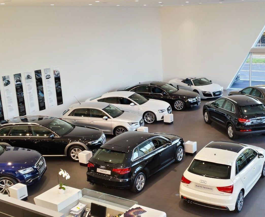 A Bunch of Cars Are Parked in a Showroom — D & J Saverino Painting & Decorating Pty Ltd In Fairy Meadow, NSW