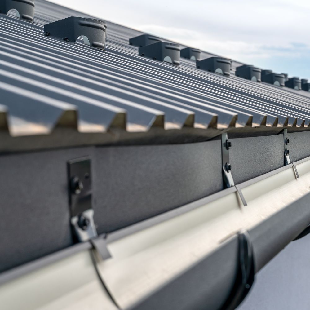 A close up of a gutter on the roof of a building