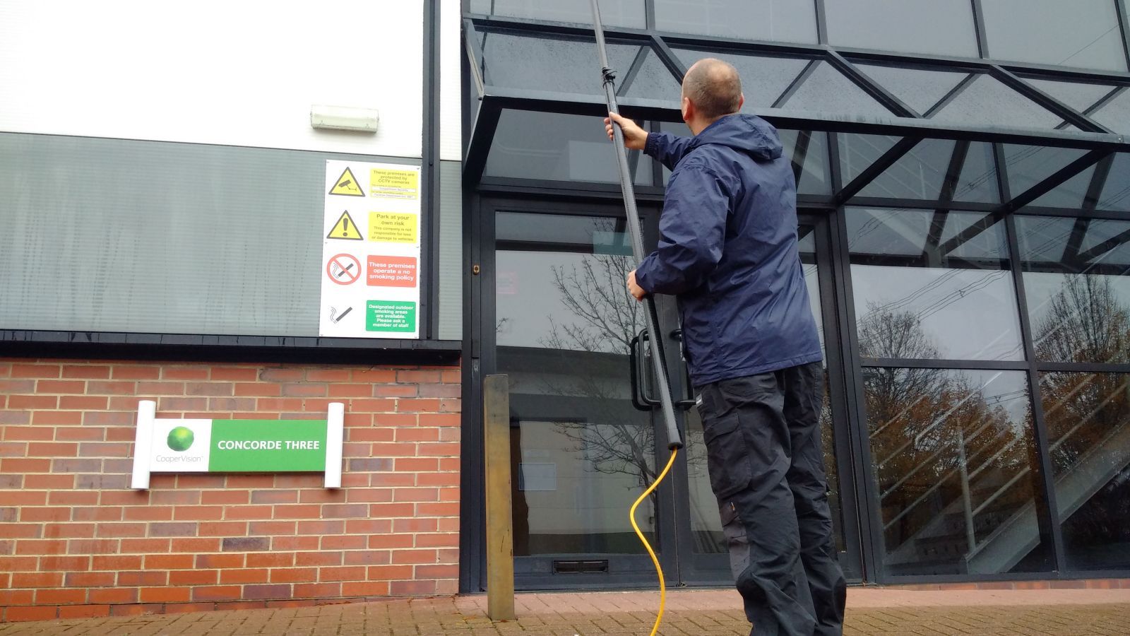 A man is cleaning the windows of a building.
