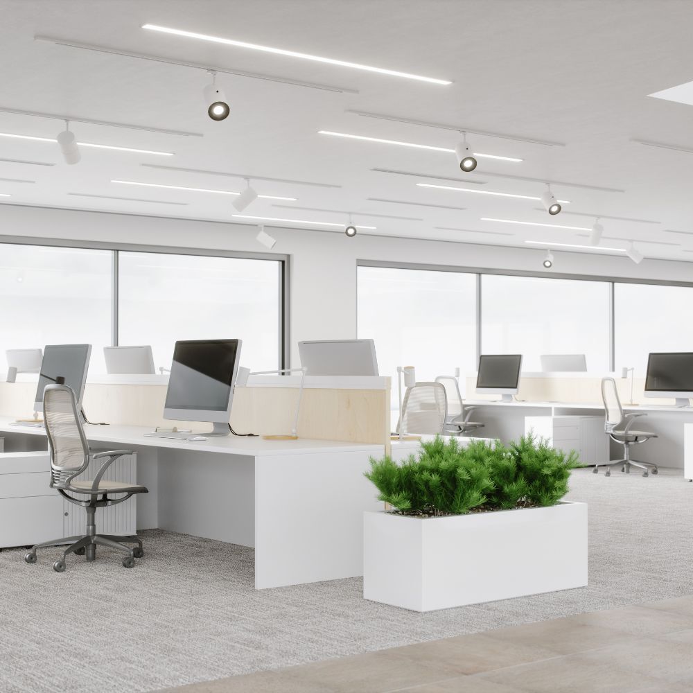 A large office with lots of desks and computers