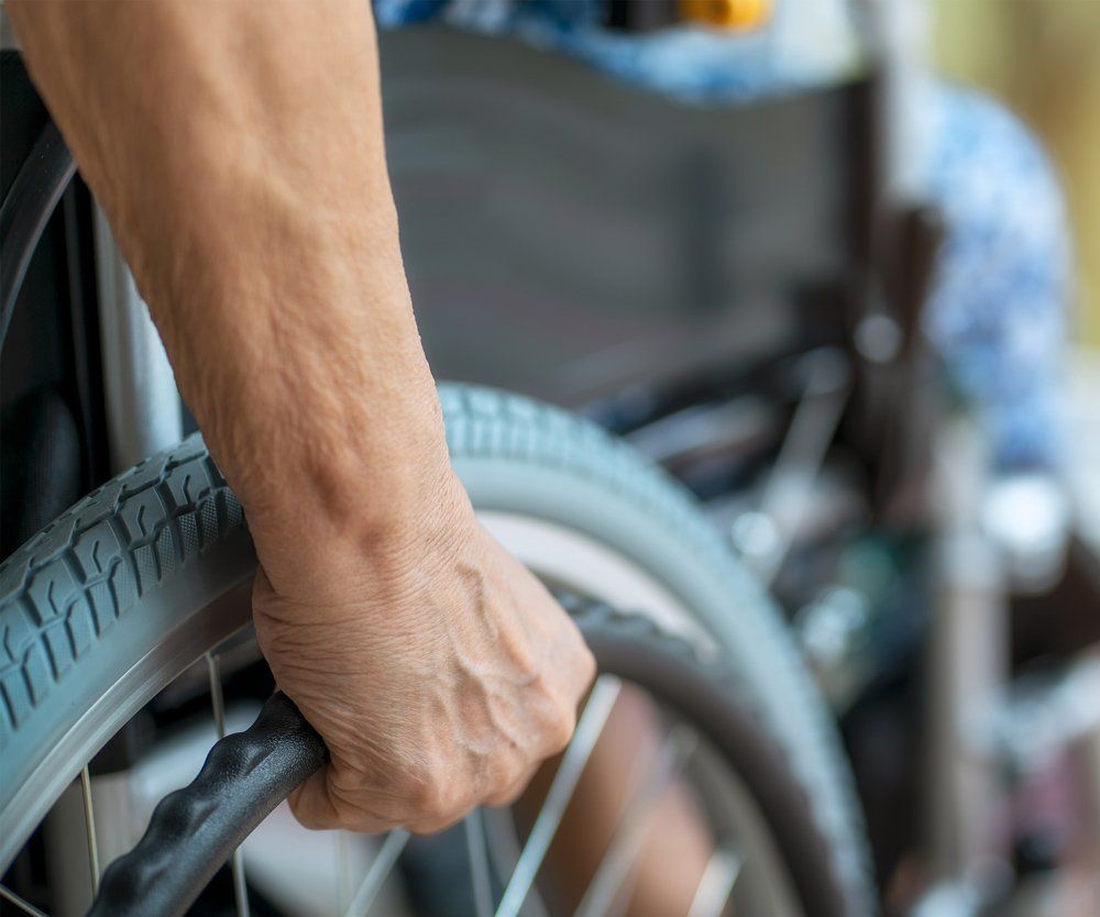 Senior Holding The Wheelchair — Irving, TX — Elite Care Transports