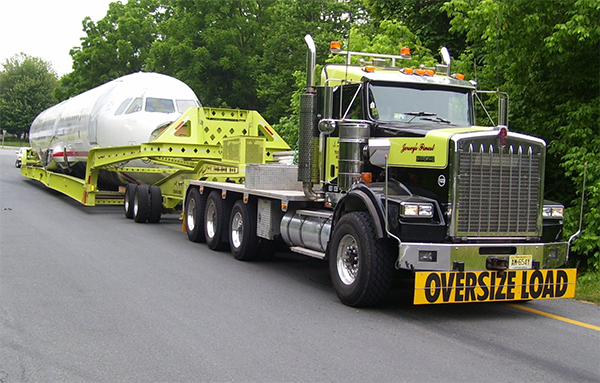 An oversize load truck is driving down the road