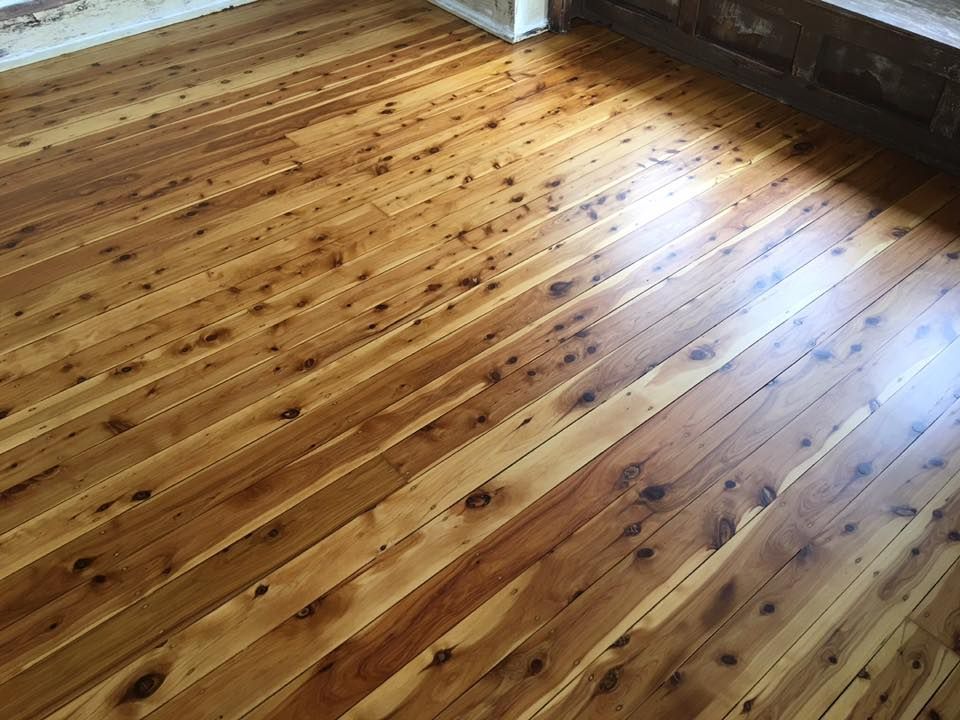 A wooden floor in a room with a window