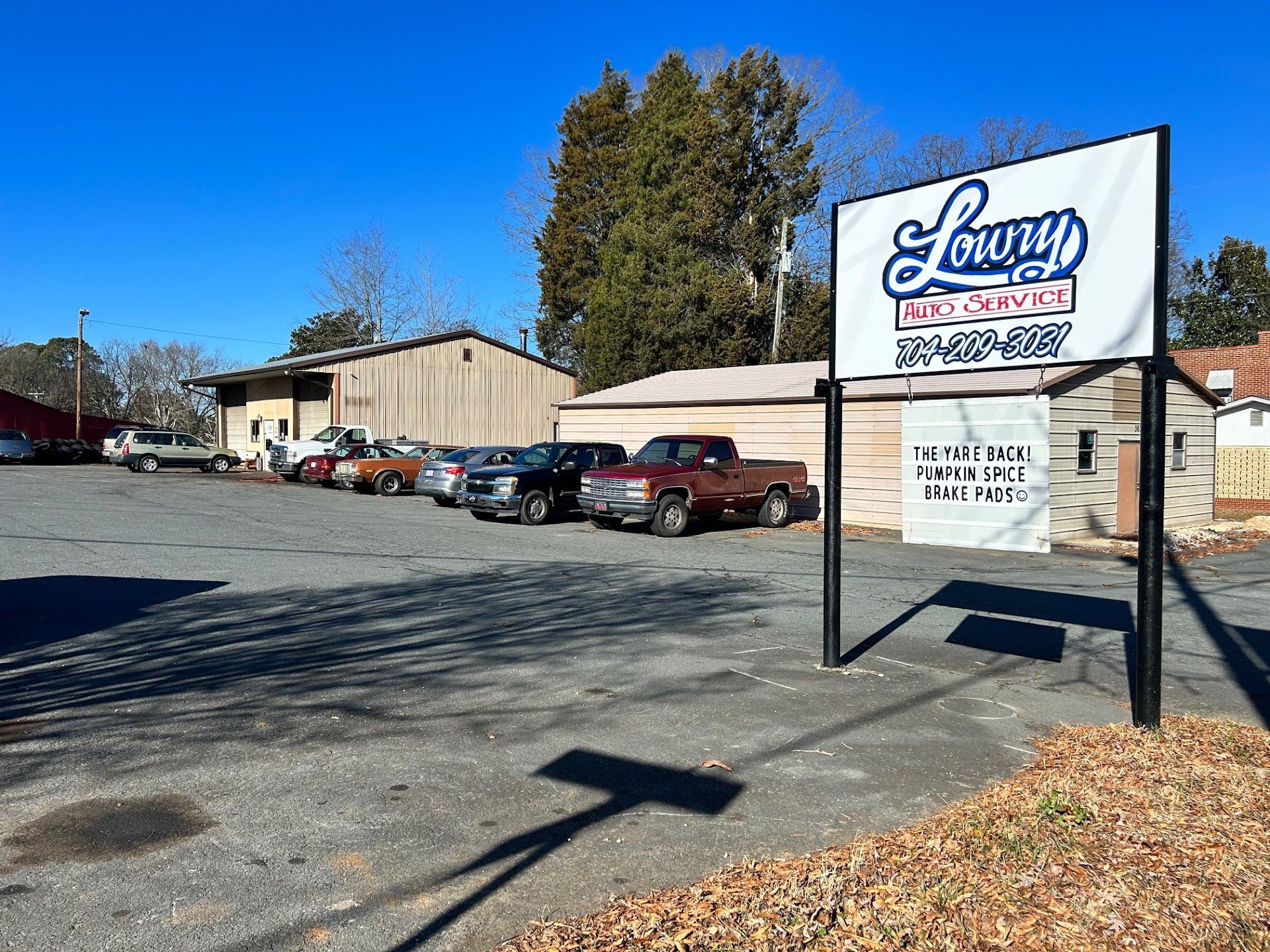 Used car lot with a shop sign | Lowry Auto Service