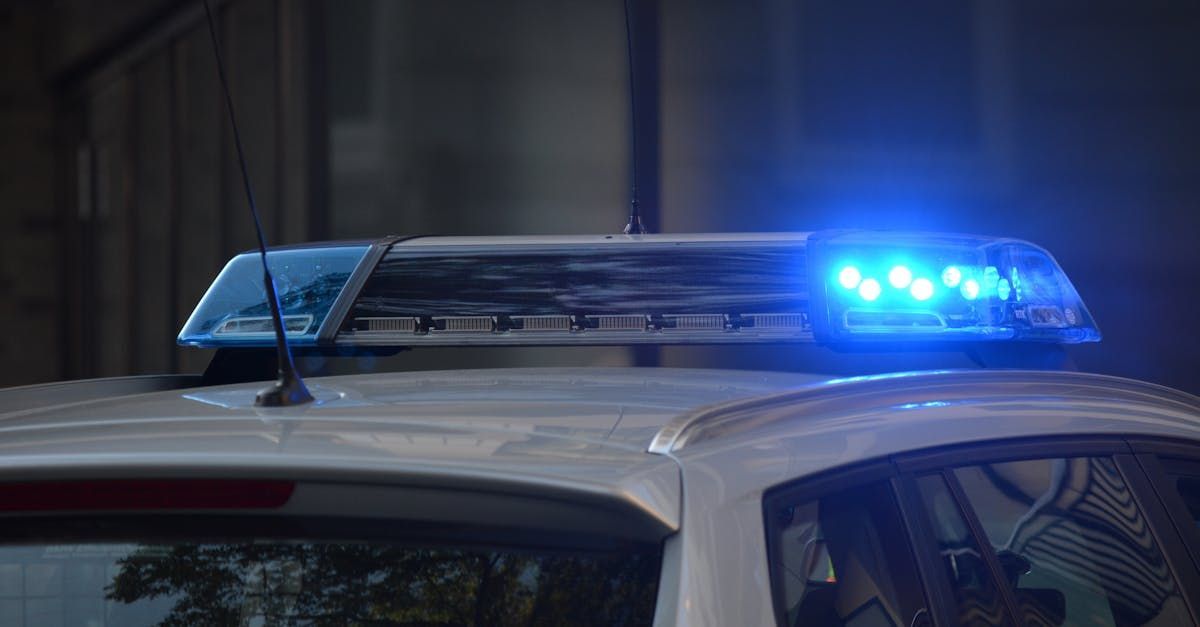 A police car with blue lights on top of it.