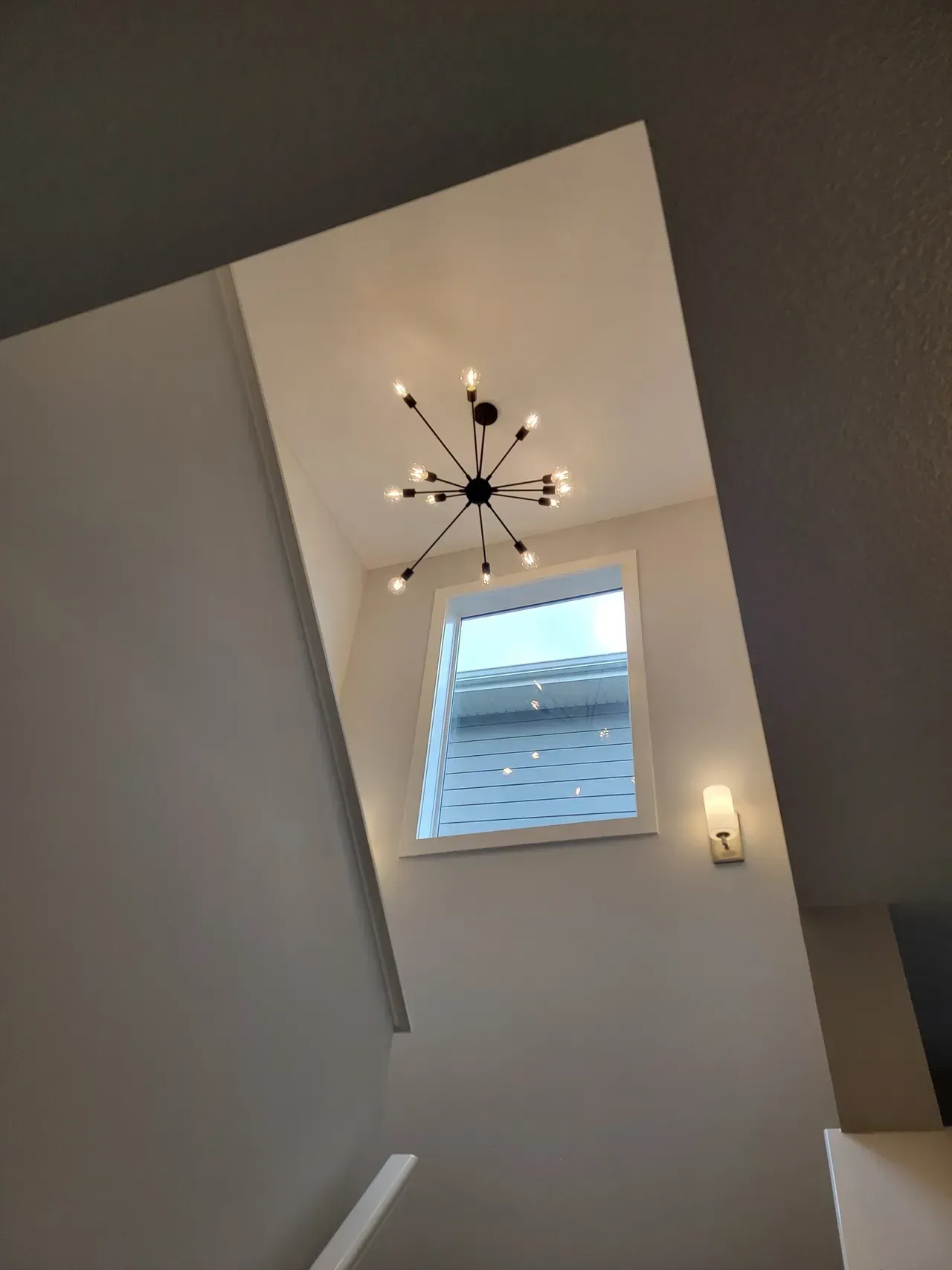 Modern chandelier and wall lighting installed by Calgary light fixture electrician