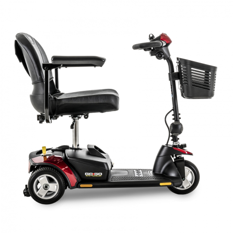 Black mobility scooter with captain’s chair, armrests, basket, and red accents on a white background