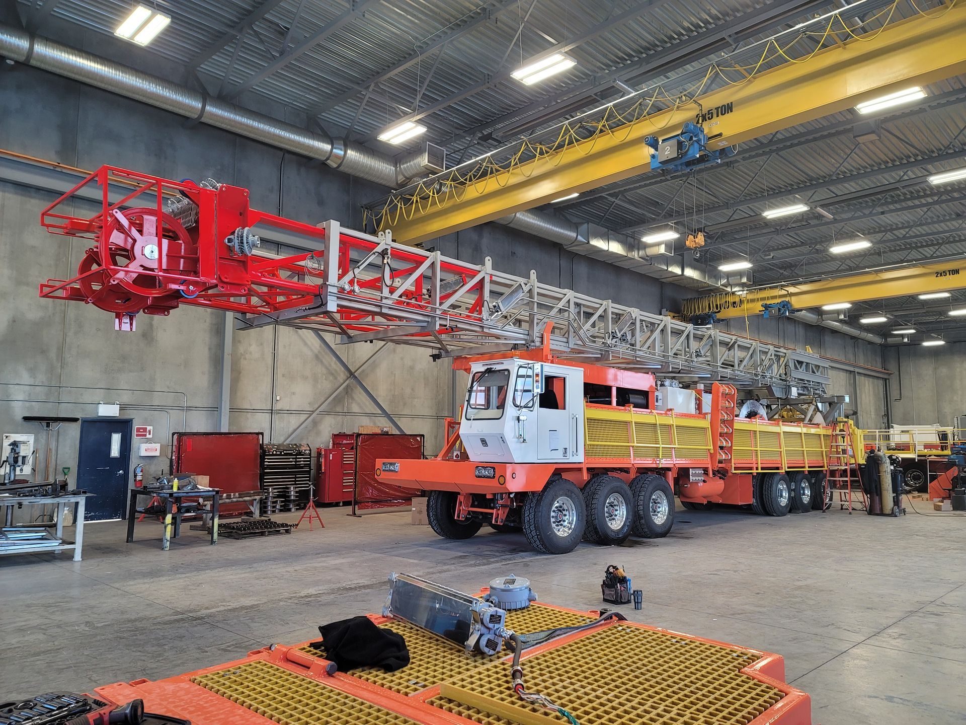 A large red and white truck is parked in a warehouse.