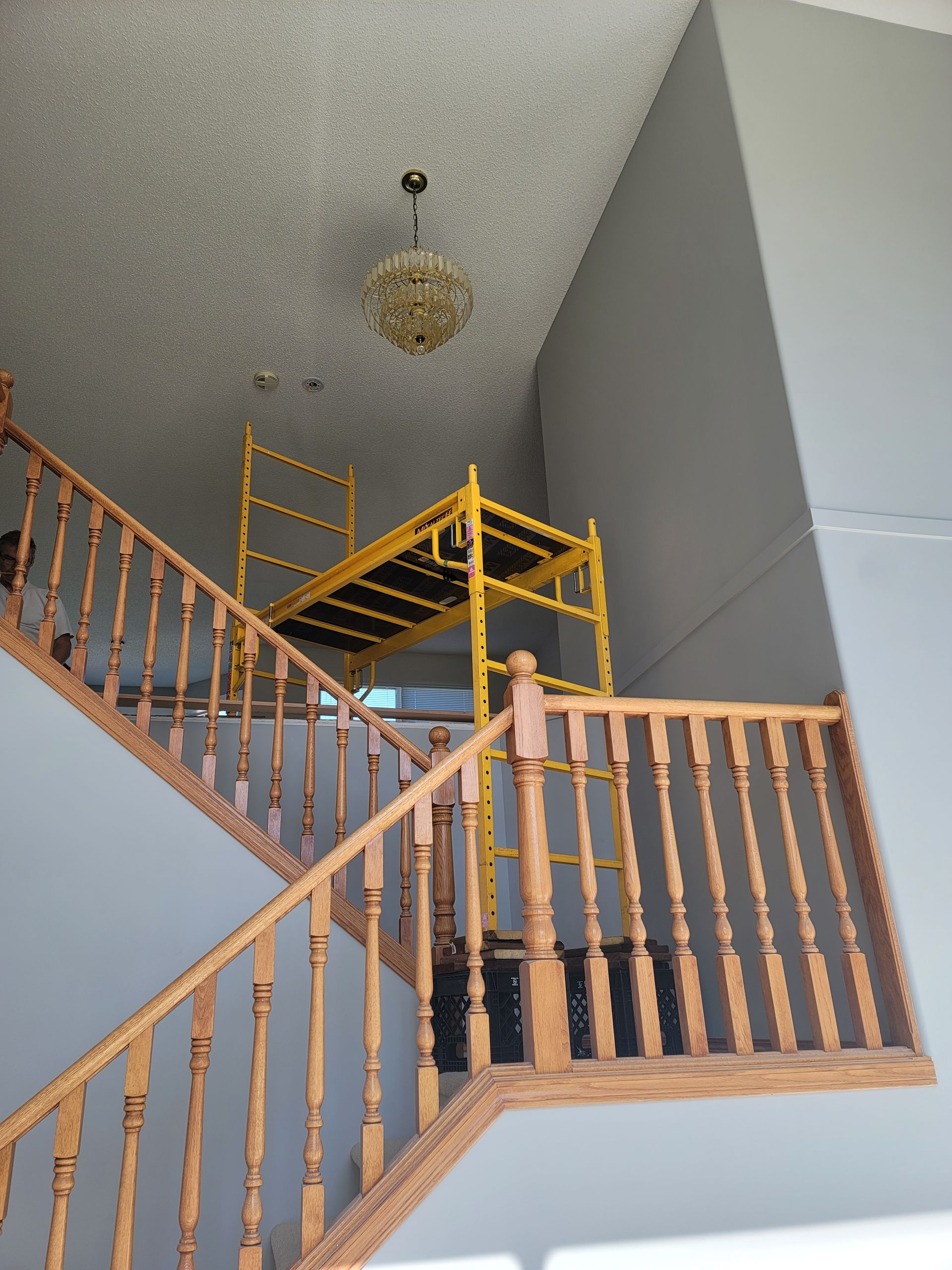 A staircase with a yellow scaffolding on top of it
