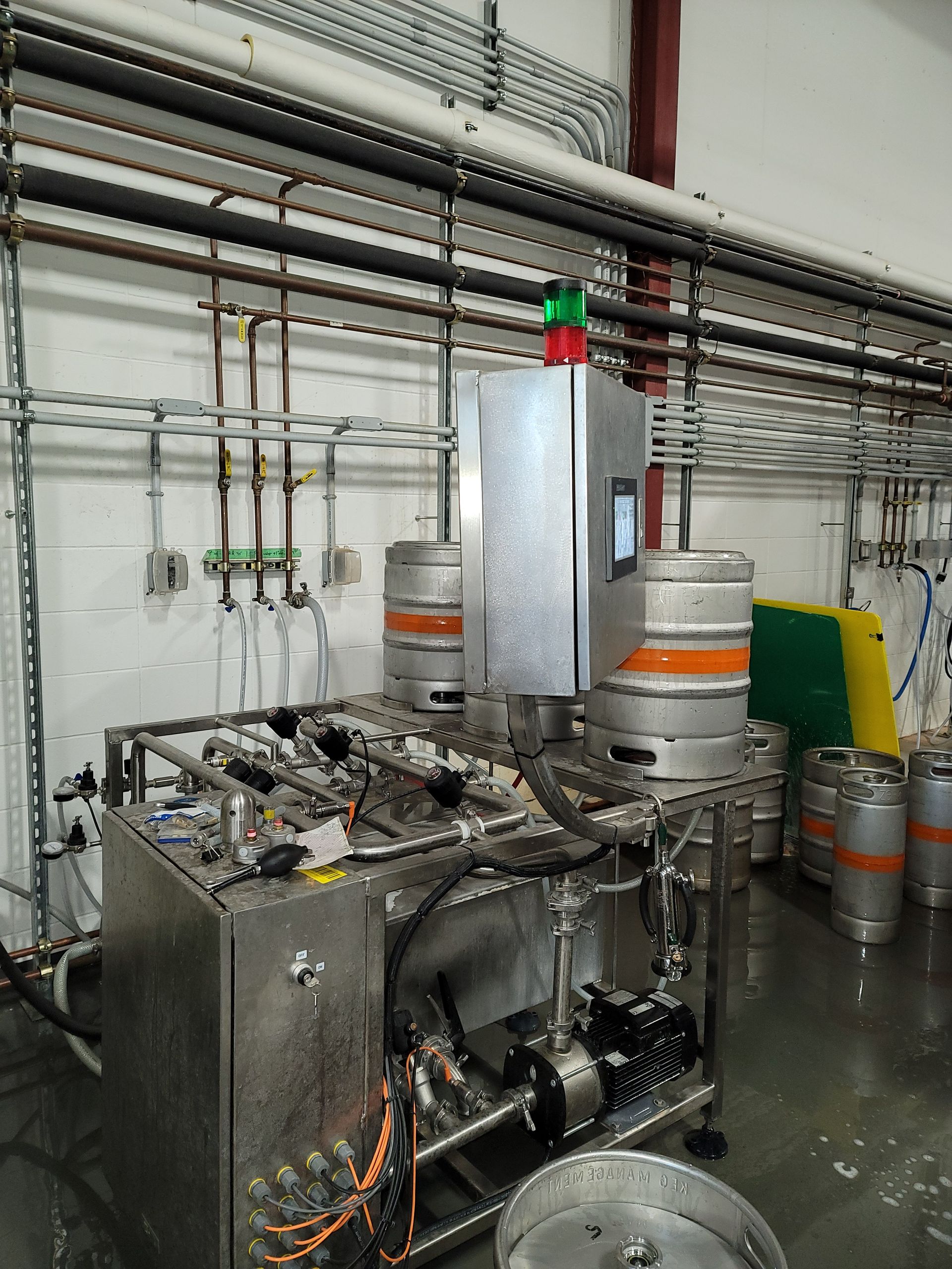 A warehouse filled with lots of kegs and a machine