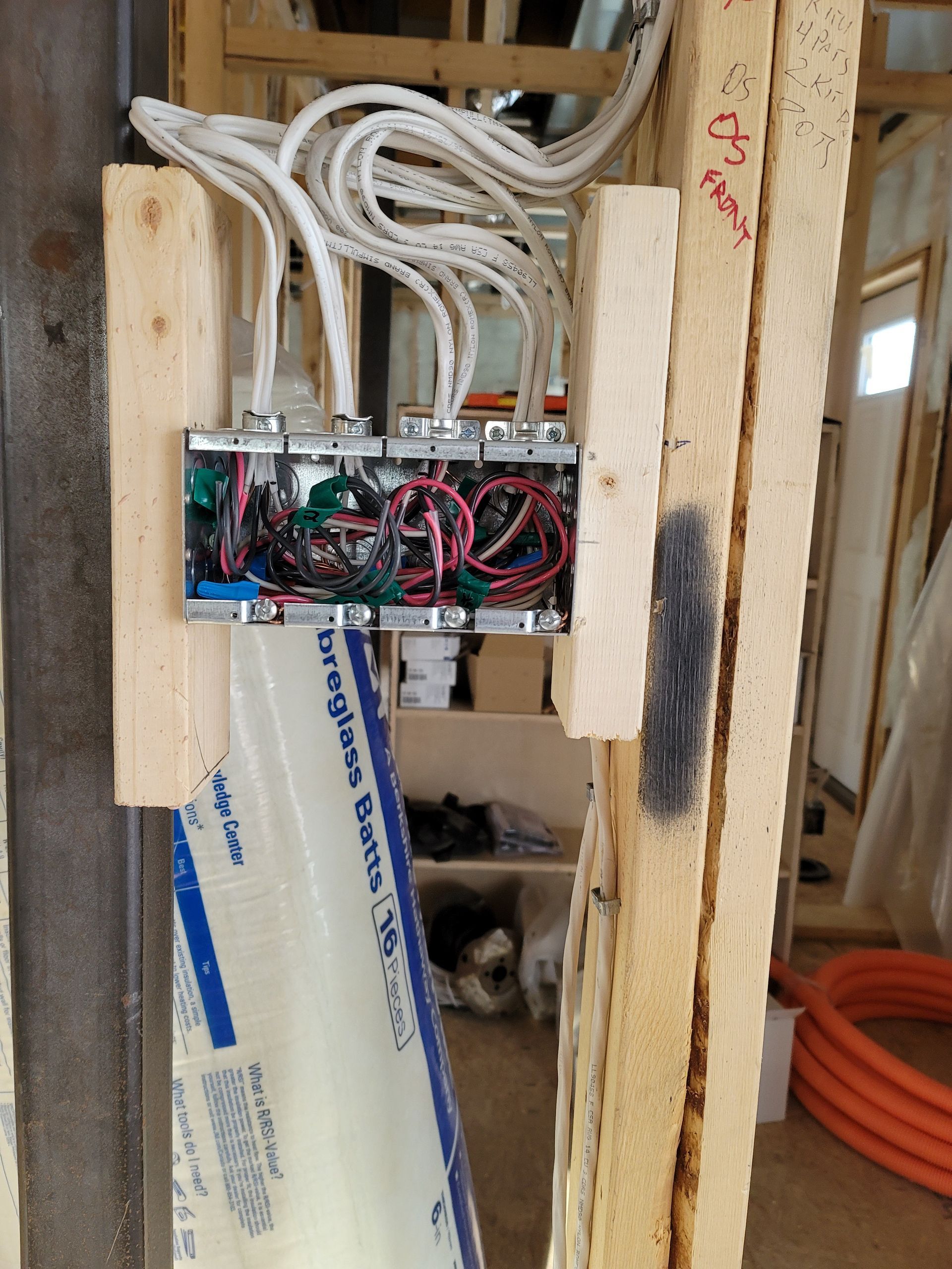 A wooden wall with electrical wires coming out of it