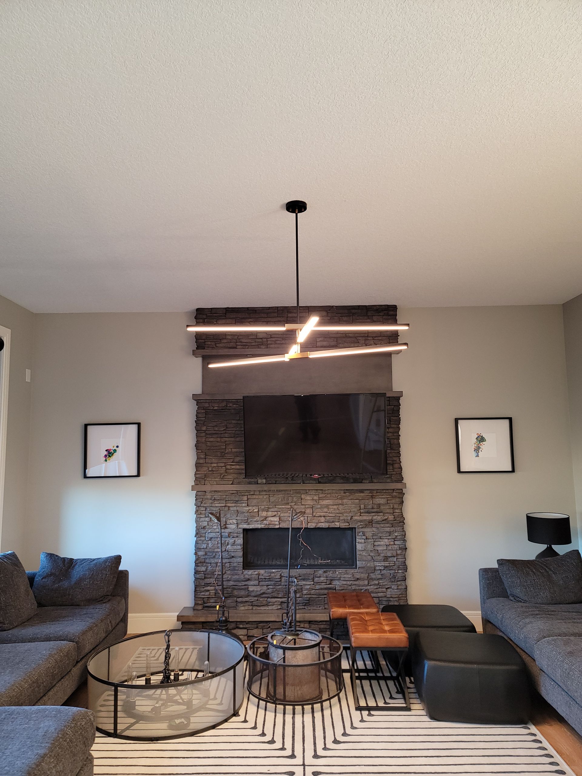 A living room with a fireplace , couch , coffee table and television.