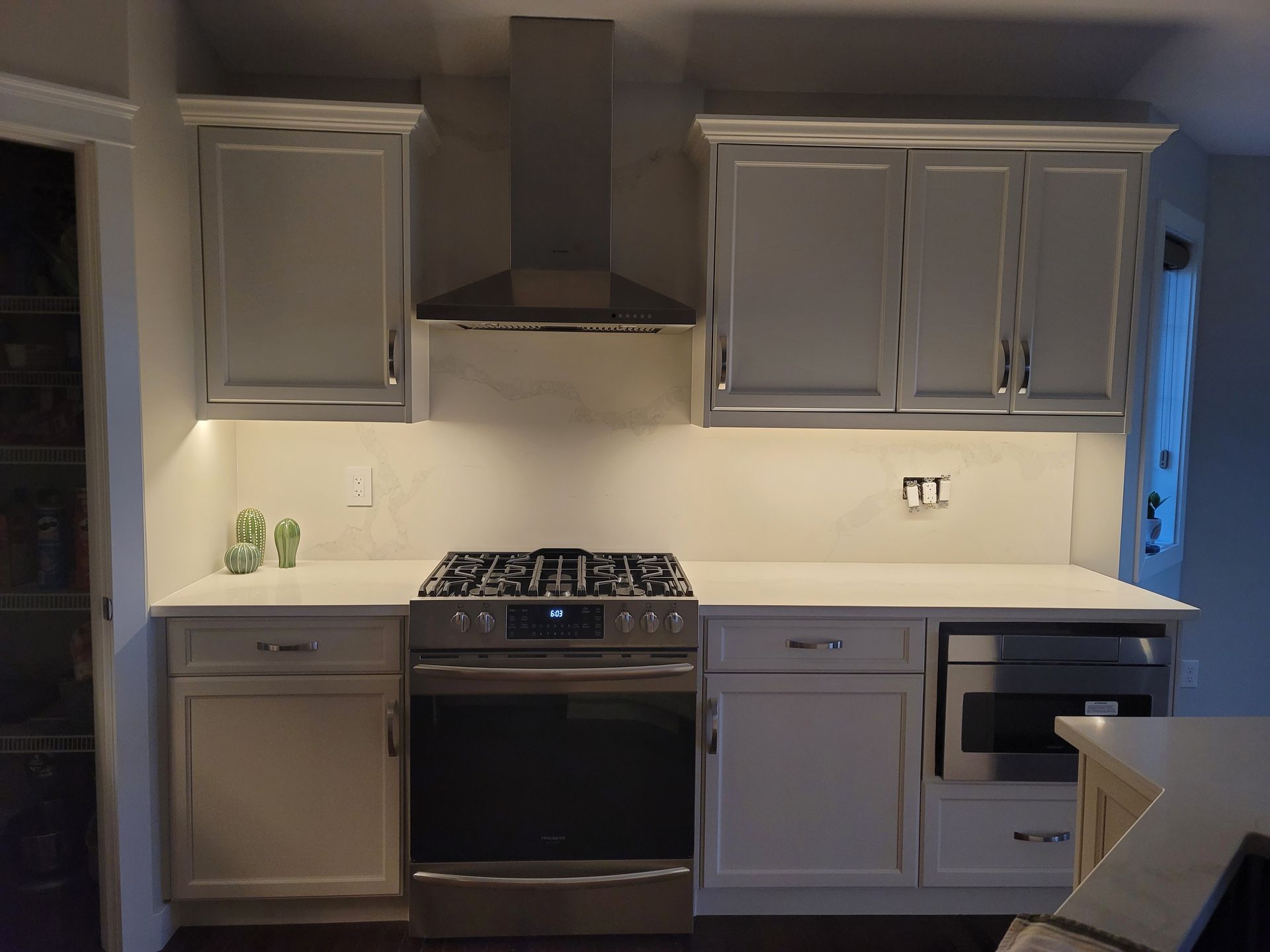 A kitchen with white cabinets and stainless steel appliances.