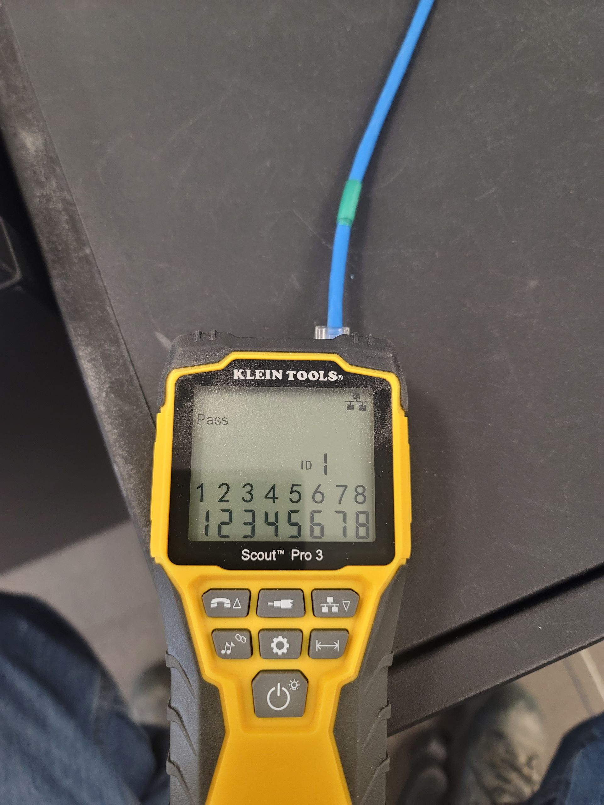 A klein tools device is sitting on a table