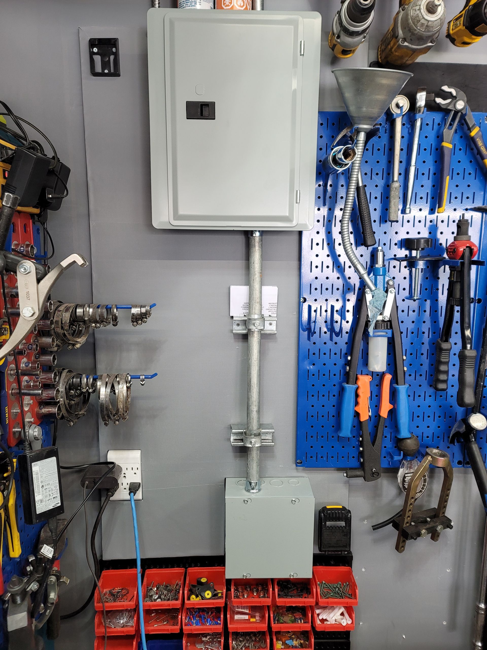 A wall with a bunch of tools hanging on it