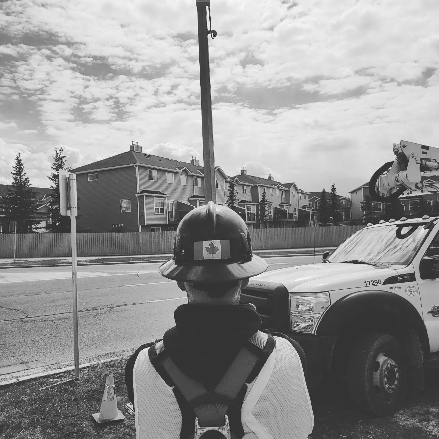 A man wearing a hard hat with a canadian flag on it
