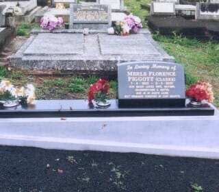 A Grave in A Cemetery with Flowers on It — Northern Rivers Headstones in Casino, NSW