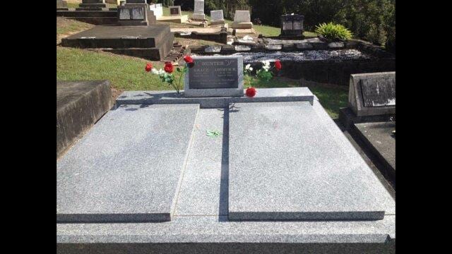 A Grave With Flowers On It In A Cemetery — Northern Rivers Headstones in Casino NSW
