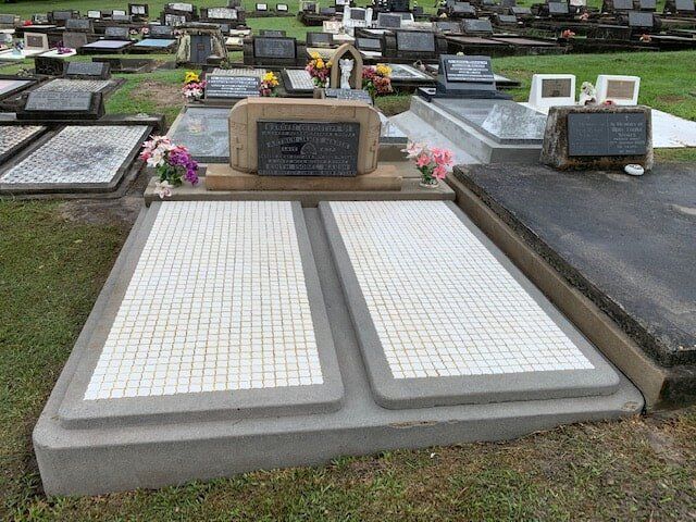 A Cemetery With A Lot Of Graves And Flowers On Them — Northern Rivers Headstones in Casino NSW