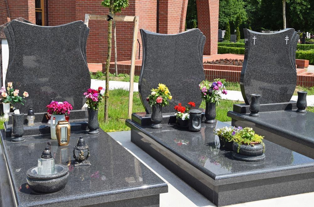 Three Graves In A Cemetery With Flowers And Candles — Northern Rivers Headstones in Lismore, NSW