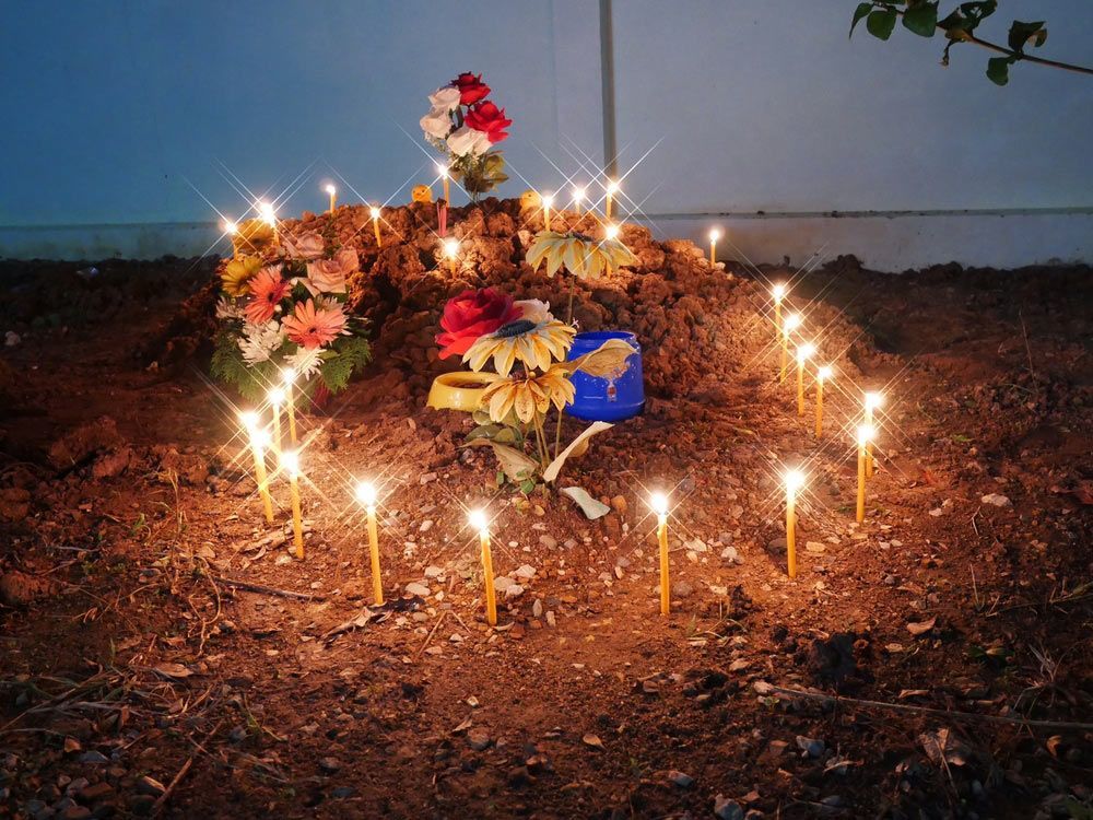 Grave With Flowers And Candles — Northern Rivers Headstones in Casino NSW
