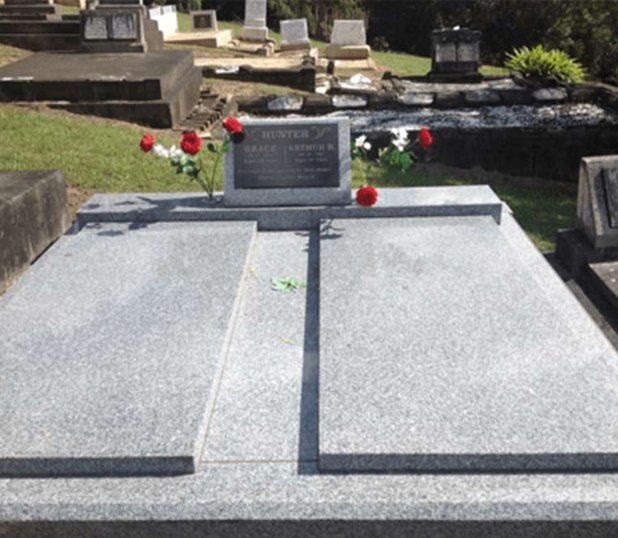 A Grave In A Cemetery With Flowers On It — Northern Rivers Headstones in Casino NSW