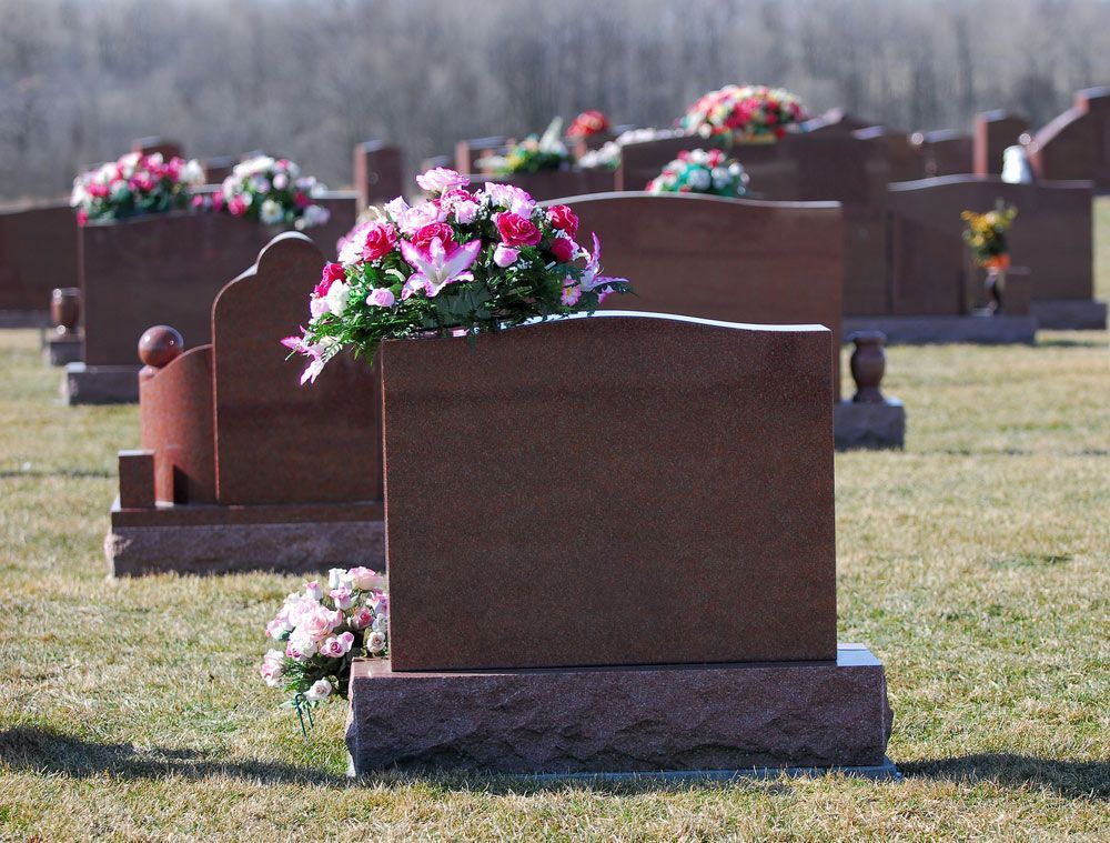 Headstones Wtih Flowers in A Cemetery