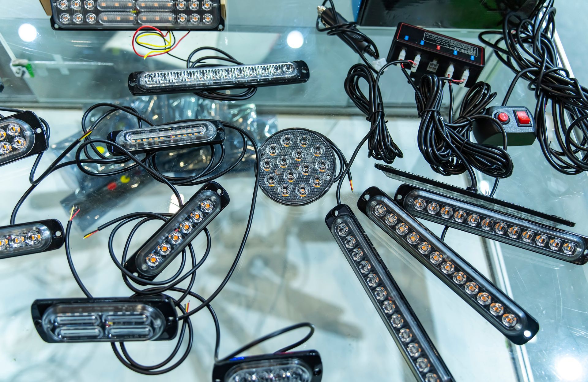 LED light bars and round lights with wiring arranged on a glass table