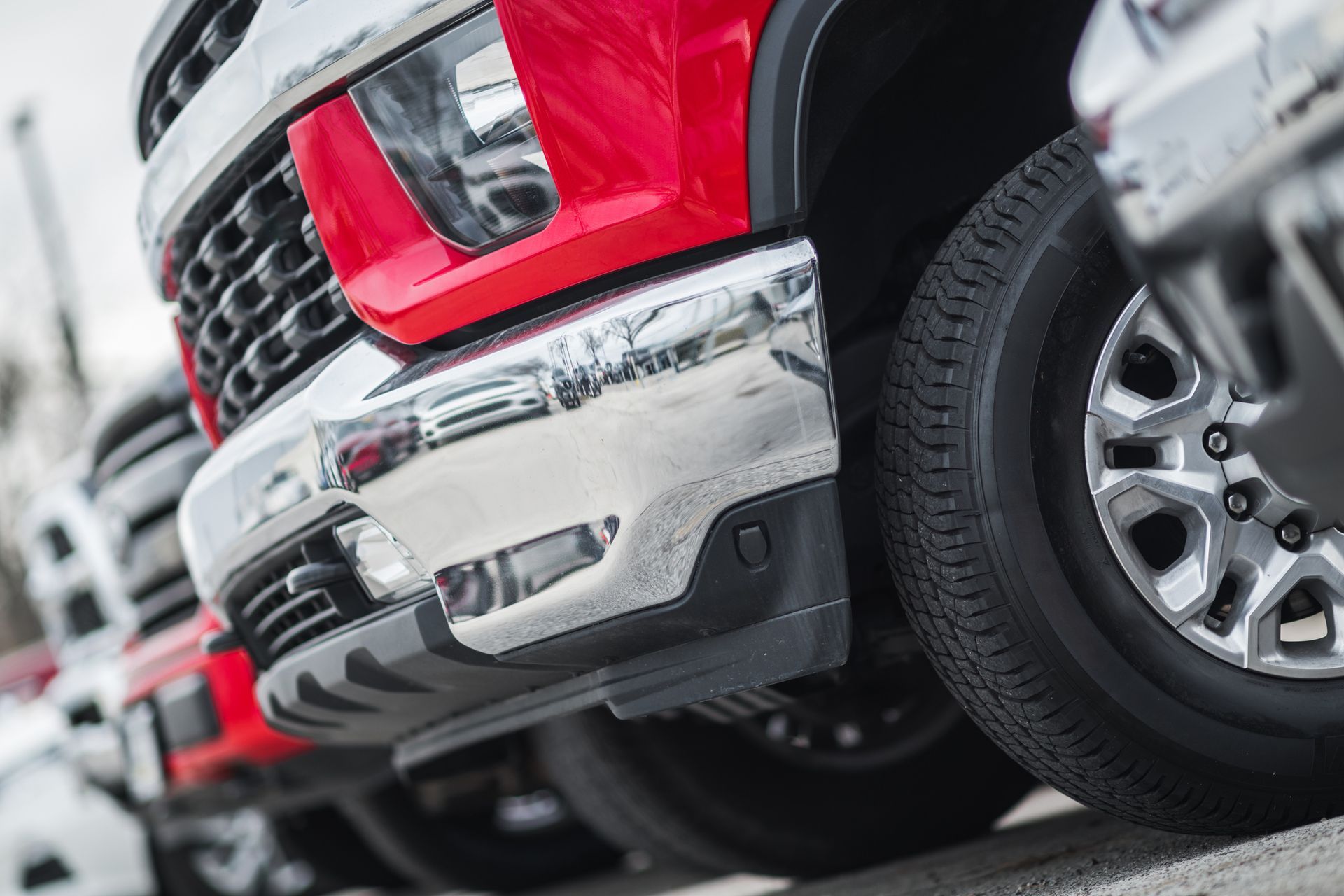 Close-up view of the front bumpers and tires of a truck.