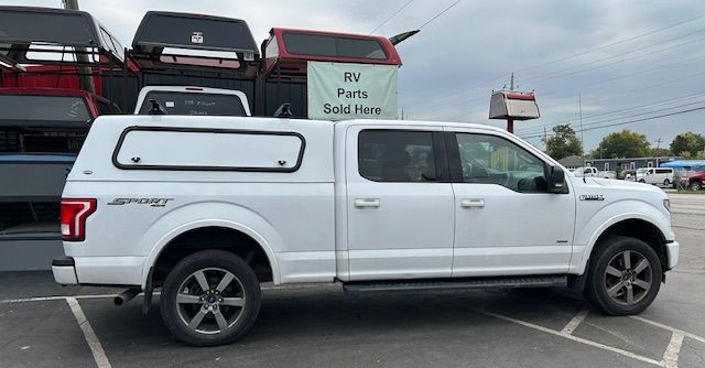 A red lashing strap thrown onto the floor of a truck body