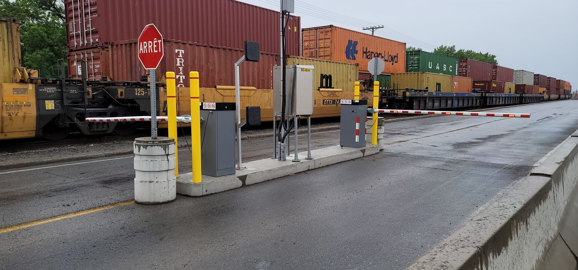 Un panneau d'arrêt rouge se trouve devant une gare de triage