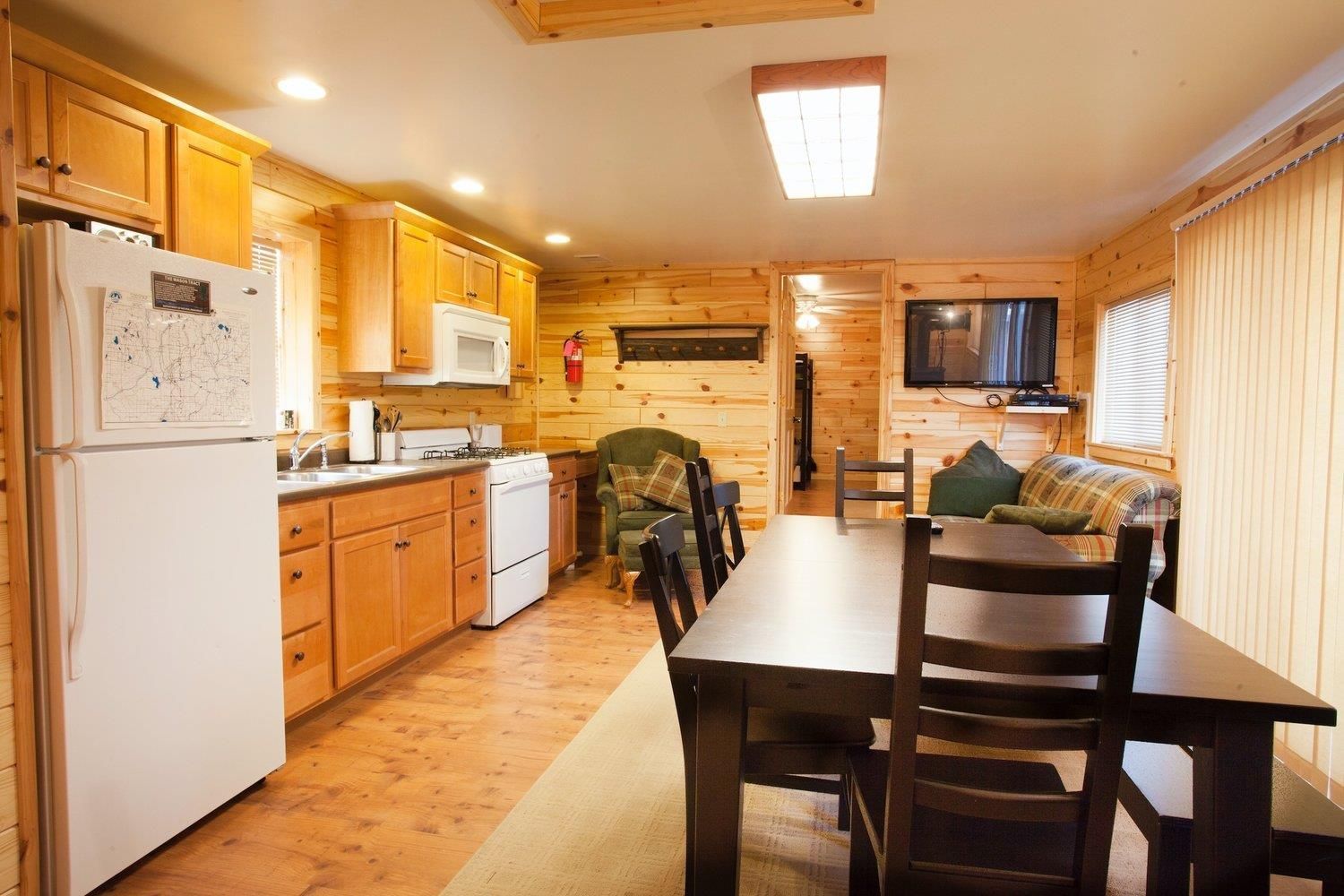 A kitchen with a table and chairs and a refrigerator