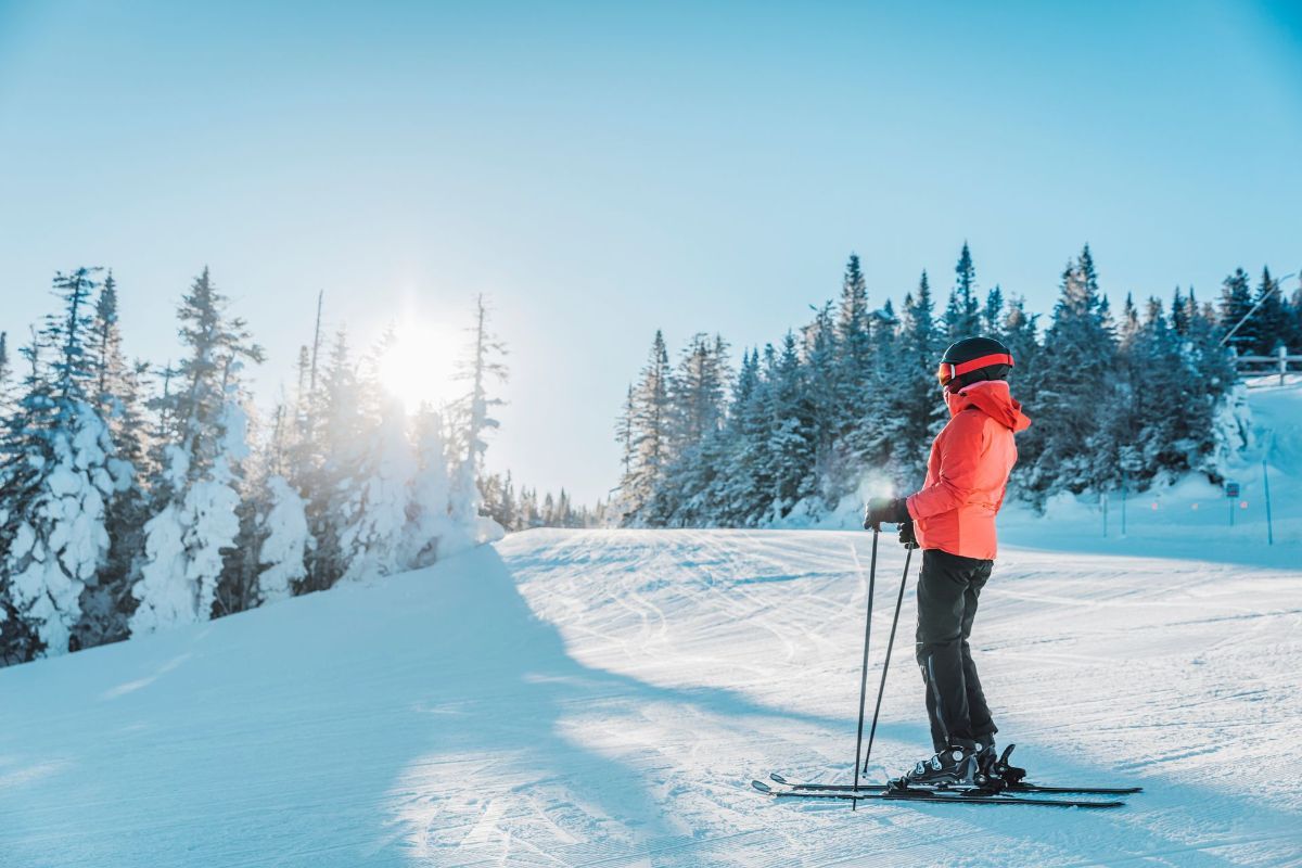 A person is skiing down a snow covered slope.