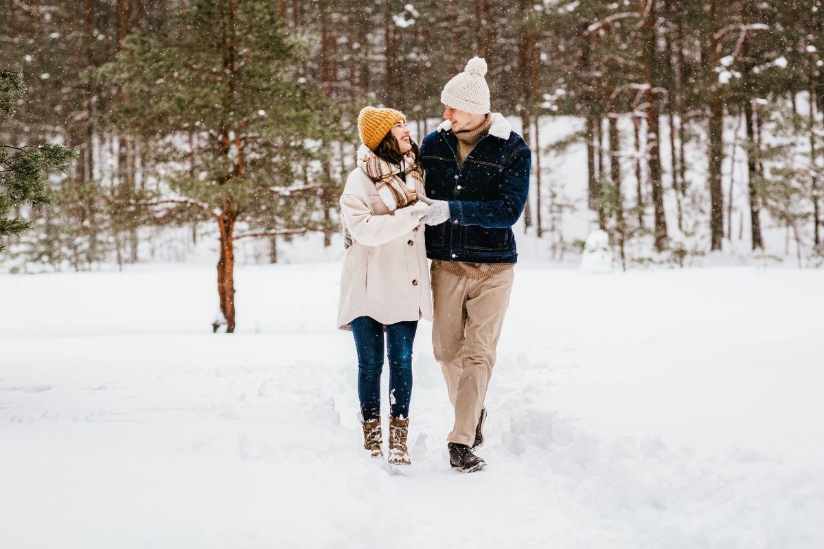 A man and a woman are walking in the snow.