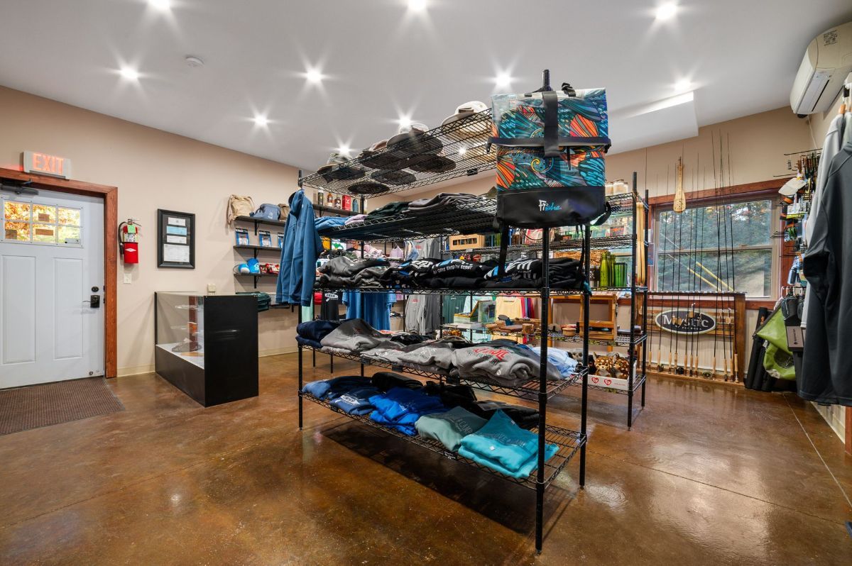 A store filled with lots of items including bottles , boxes , and wooden crates.