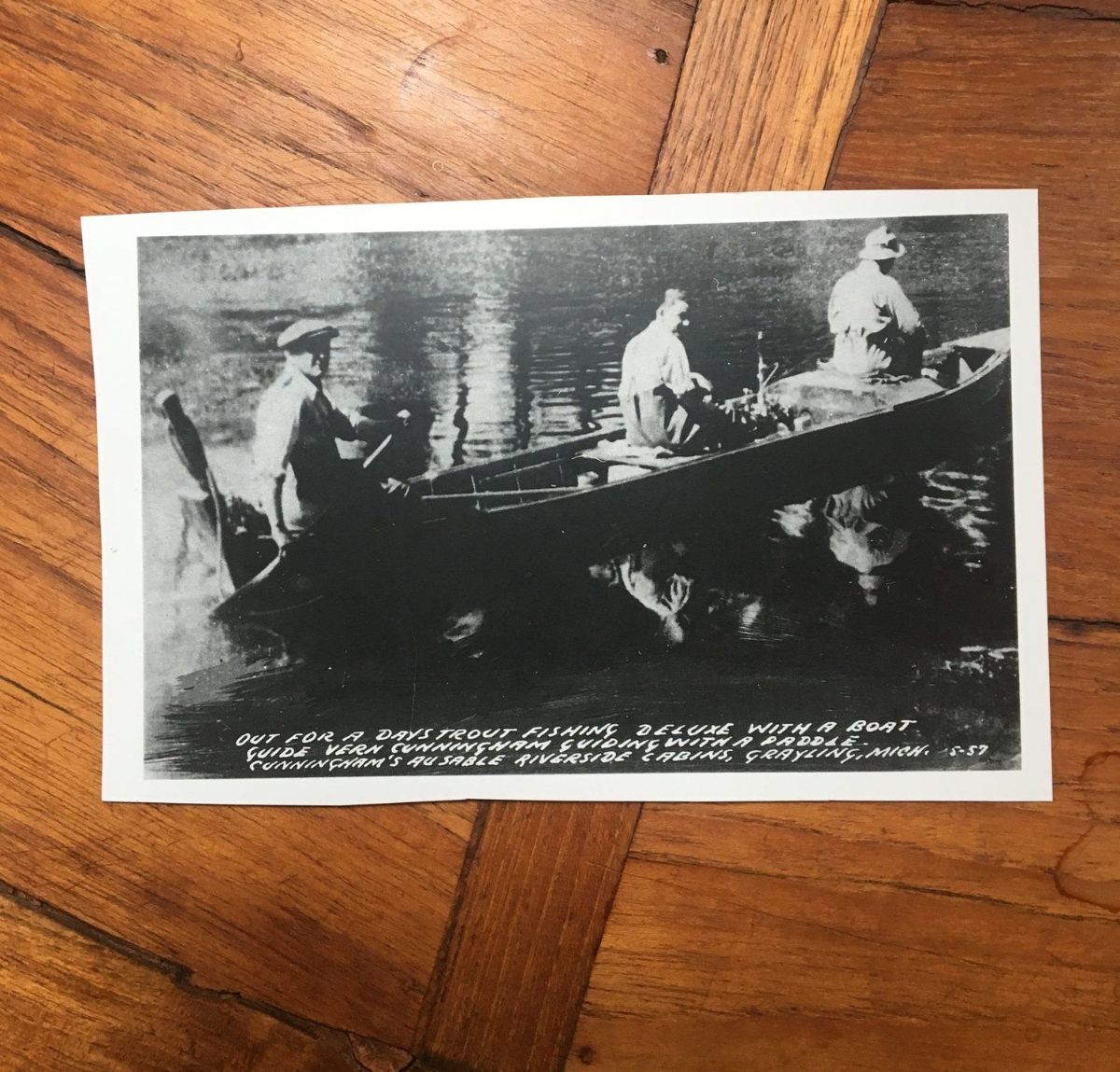 A black and white photo of people in a boat
