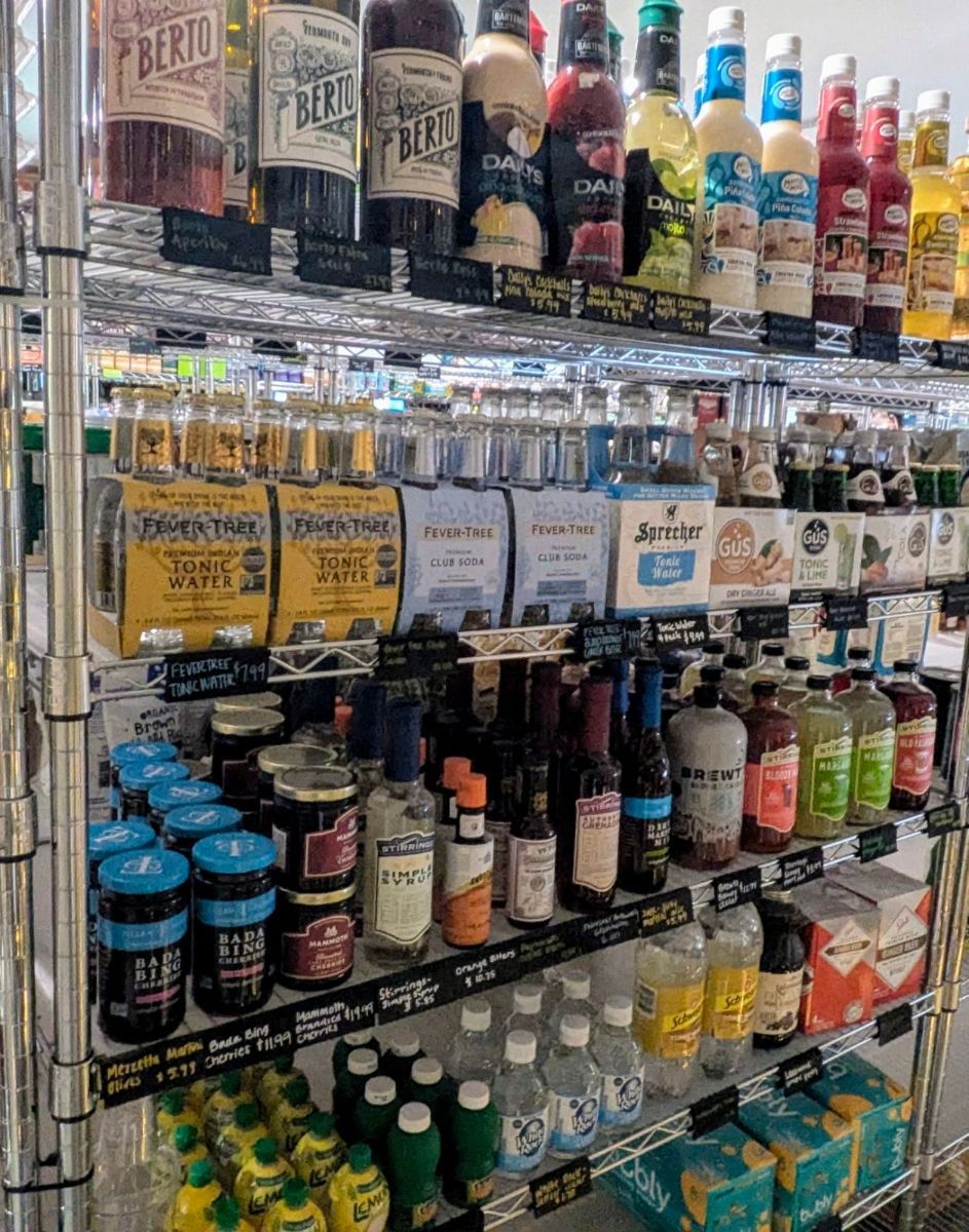 A store shelf filled with lots of bottles of liquor.